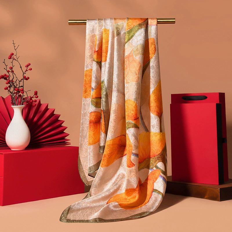 Warm orange floral long silk scarf with Chinoiserie-inspired print and smooth luxury silk finish.