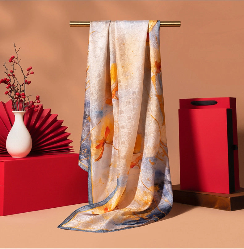 Ivory gold printed silk scarf with vintage floral artwork, long oblong shape, and soft elegant sheen.