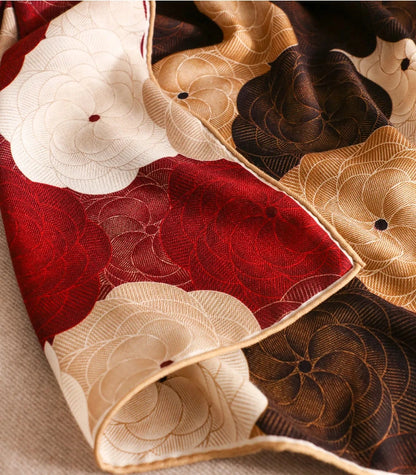 Close-up of vintage floral silk wool blend scarf with brown burgundy and cream pattern.