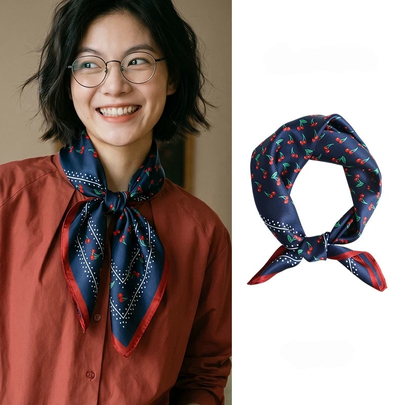 Vintage navy cherry mulberry silk square scarf styled around the neck and displayed in a knotted shape