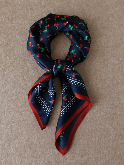 Vintage navy cherry silk square scarf tied in a neat knot with contrasting red trim
