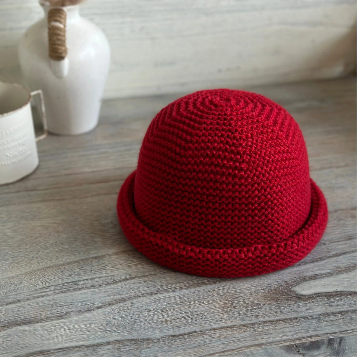 Vintage red rolled brim knit beanie with a sculpted round crown displayed at a slight angle