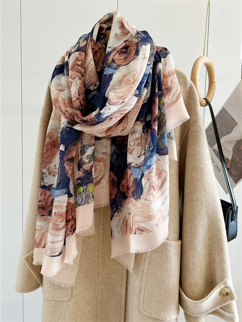 Vintage rose wool scarf loosely looped over a beige coat with long floral ends draping in front
