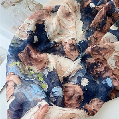 Close-up of painterly rose print on wool scarf in blush pink, cream, cocoa brown and navy blue
