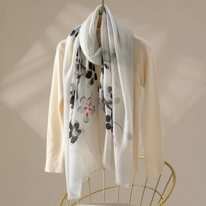 Black watercolor floral 100% wool scarf for women draped over a cream sweater