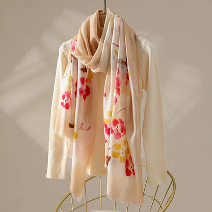 Light coffee floral 100% wool scarf for women draped over a cream knit top