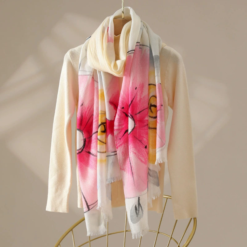 Light pink watercolor floral 100% wool scarf draped over a cream sweater