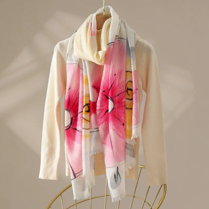 Light pink watercolor floral 100% wool scarf draped over a cream sweater