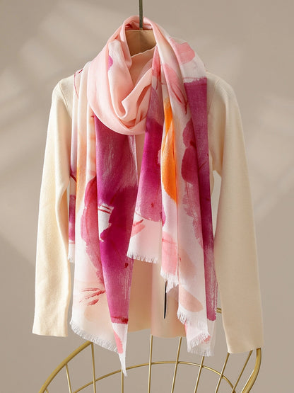Orange floral print wool scarf for women draped elegantly over a cream sweater