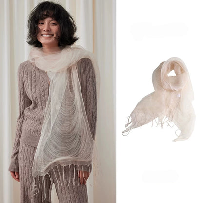 Woman wearing a wheat white sheer mulberry silk fringe scarf over a taupe sweater