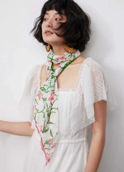 Model wearing a white floral silk scarf for fresh and elegant summer styling