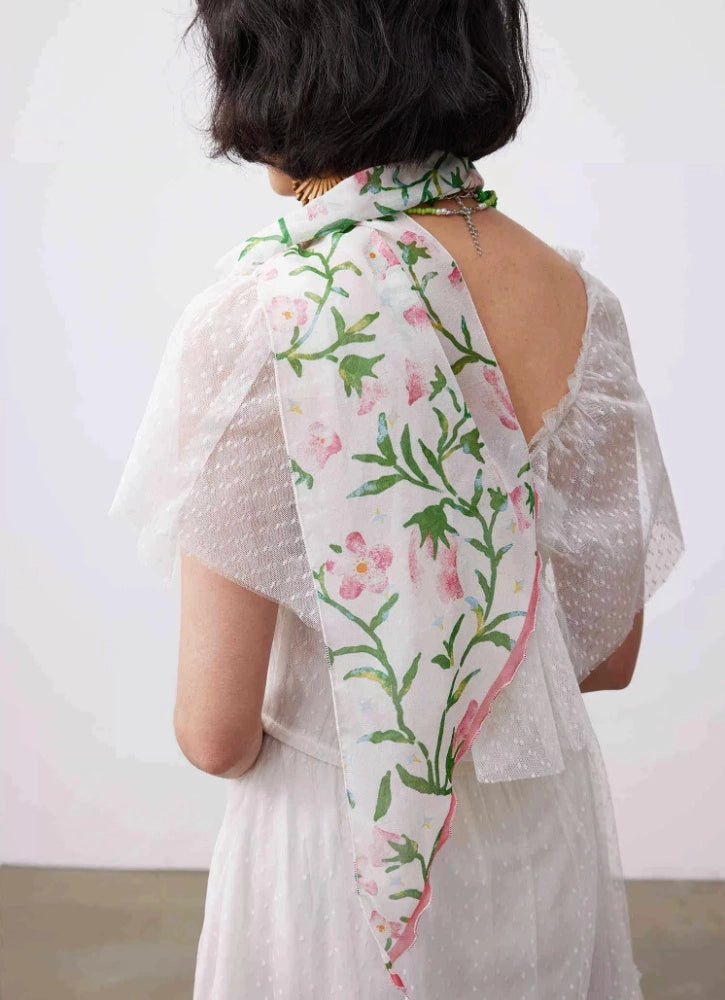 White morning glory long silk scarf draped from the neck with soft floral print