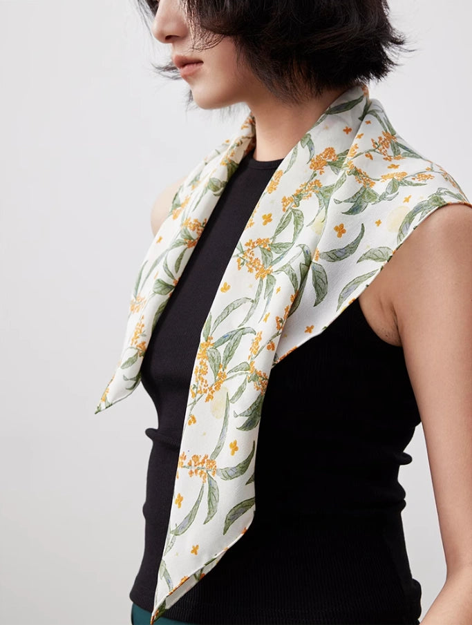 White osmanthus silk square scarf draped gracefully, emphasizing its smooth texture and timeless design.