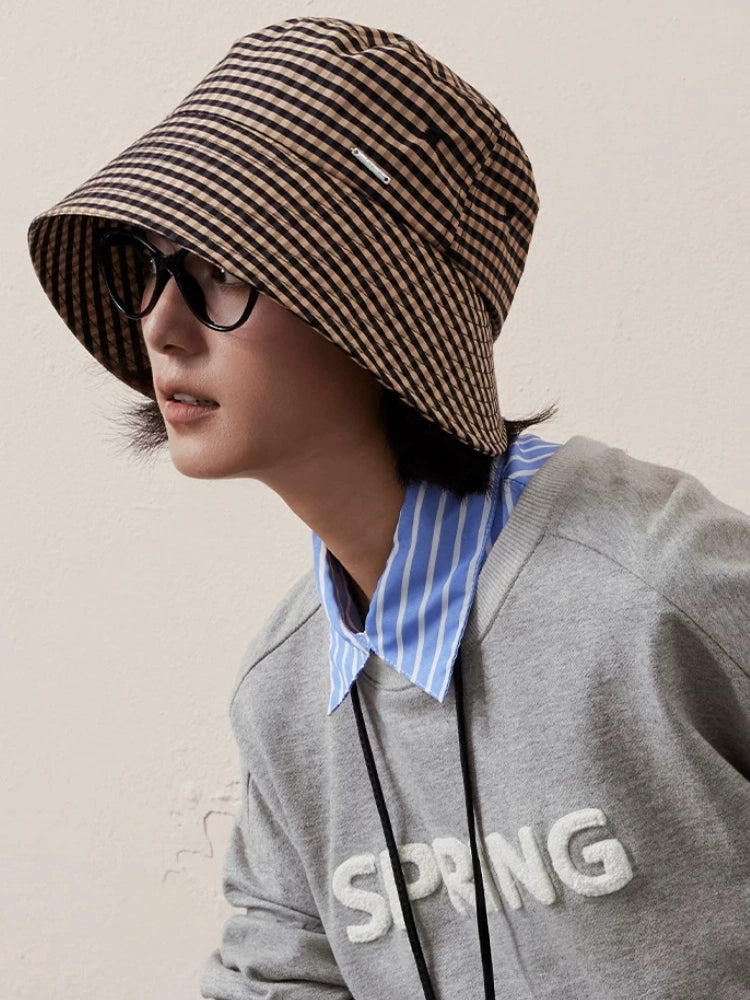 Woman wearing a black coffee plaid wide brim ponytail bucket hat in casual street style