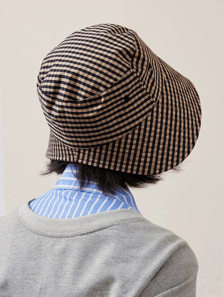 Rear view of black coffee plaid ponytail bucket hat with U-shaped back opening