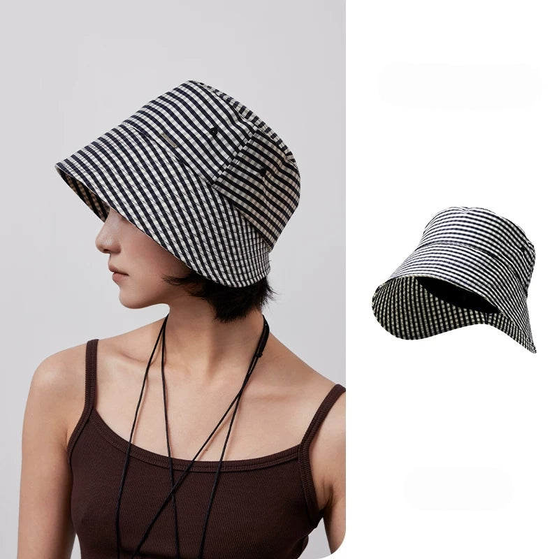 Women's black and white plaid ponytail bucket hat with wide brim and open back design