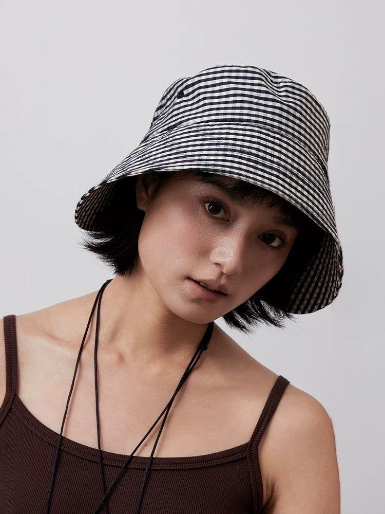 Front view of women's black and white check bucket hat with soft wide brim