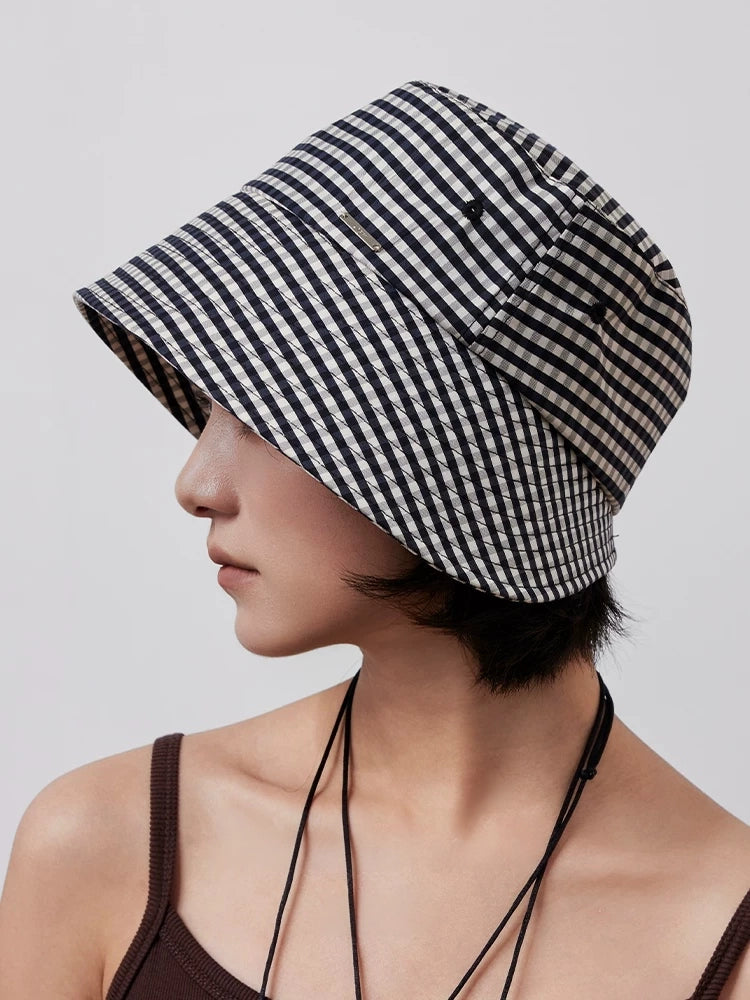 Side view of black and white plaid ponytail bucket hat with structured wide brim