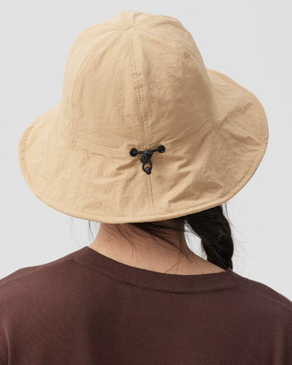Close-up rear view of a khaki bucket hat showing the black drawstring toggle, crown seams and wide brim.