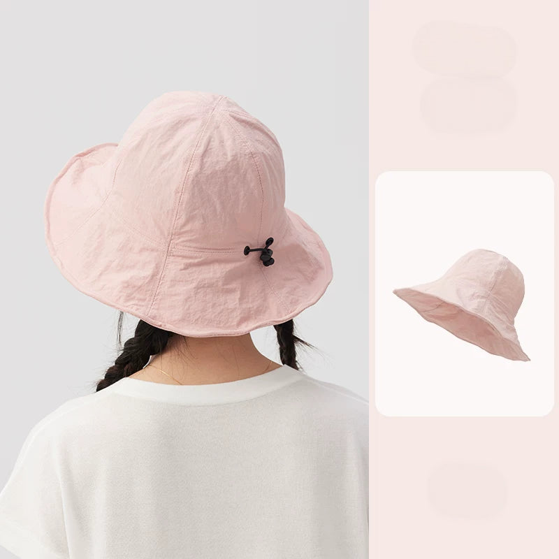 Rear view of a pale pink wide brim bucket hat with an adjustable drawstring, alongside a matching product inset.