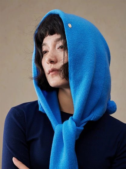 Close-up of woman wearing a royal blue wool hooded scarf tied at the neck