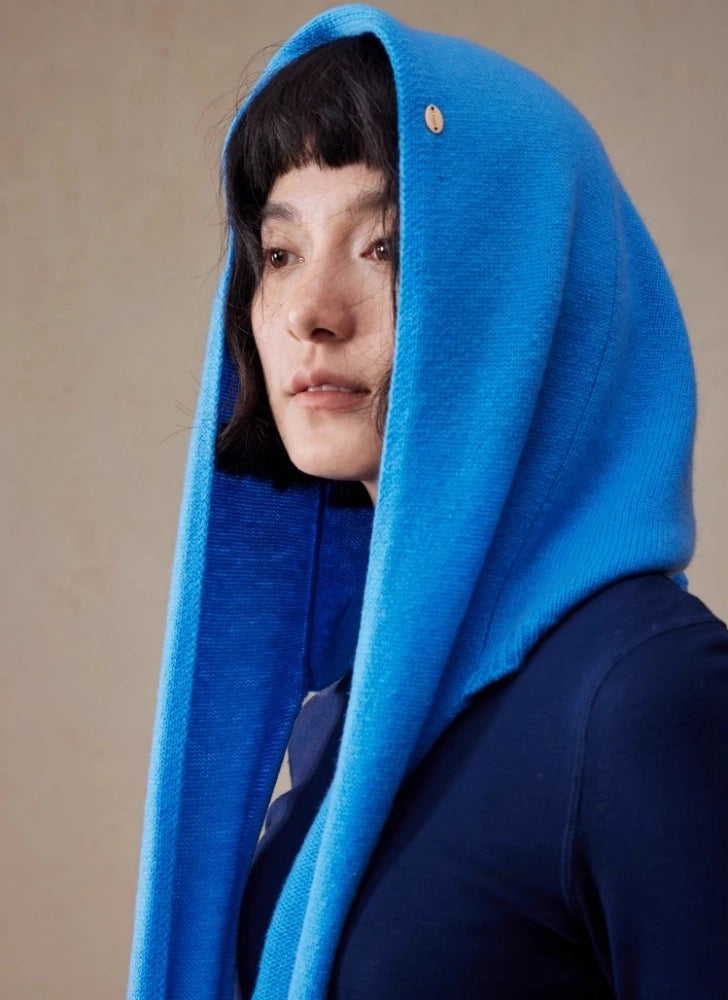 Close-up side view of woman wearing a royal blue wool hooded scarf with hood up