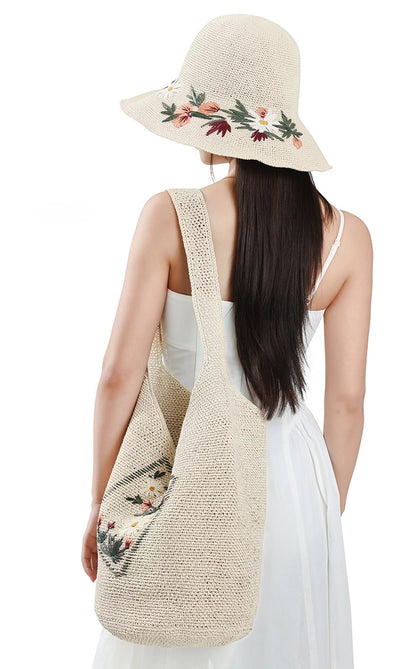 Woman carrying ivory woven straw shoulder bag with floral embroidery for summer resort styling