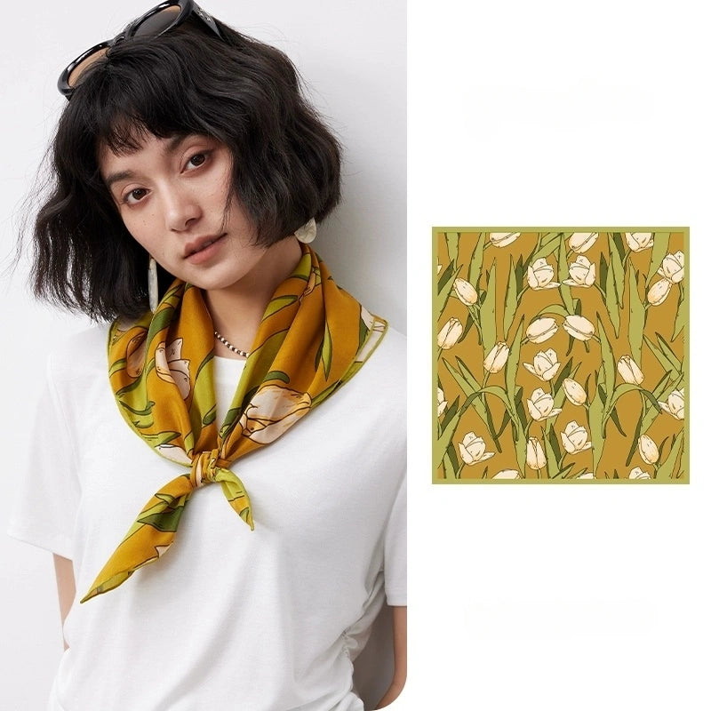 A yellow tulip floral print silk square scarf made from 100% mulberry silk is shown in a close-up.