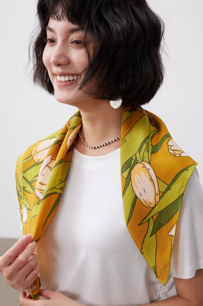 A yellow tulip floral print silk square scarf made of 100% mulberry silk, displayed as the front of a shawl.